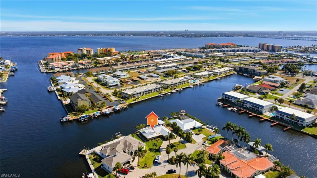 Image 1: Aerial view of property and surrounding area with a nearby body of water