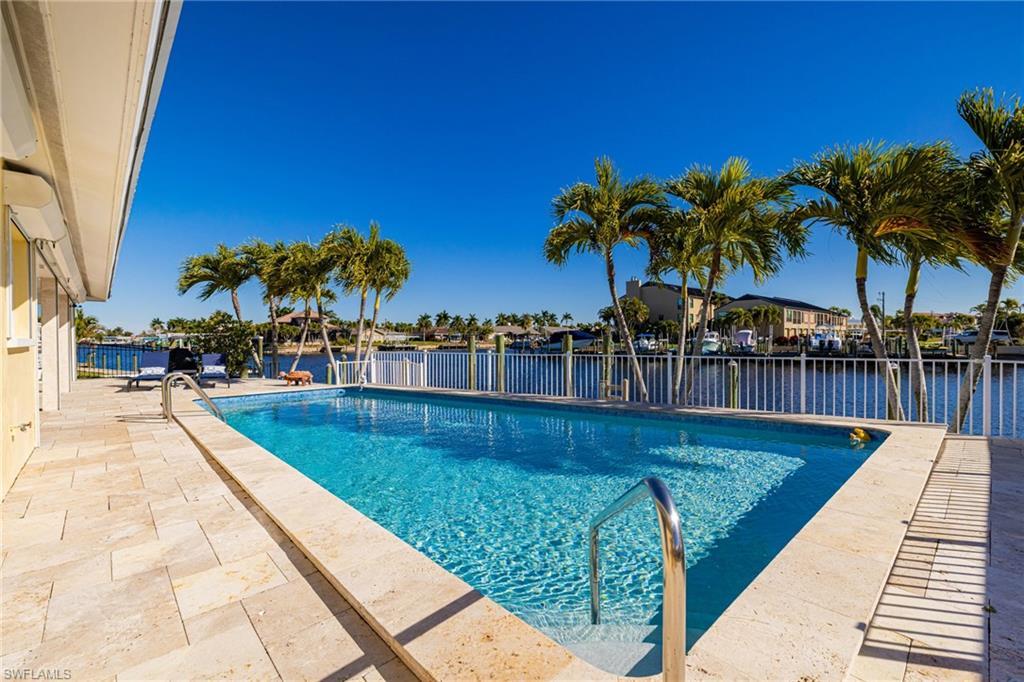 Image 2: View of pool featuring a patio area and a residential view