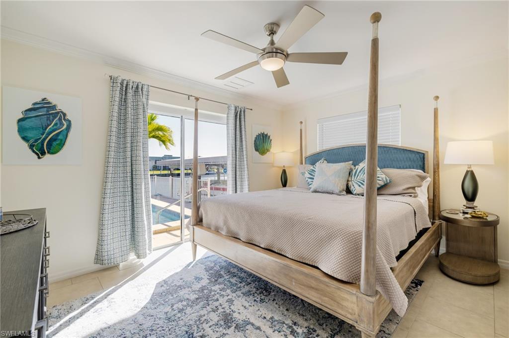 Image 4: Bedroom featuring access to outside, light tile patterned flooring, a ceiling fan, and ornamental molding