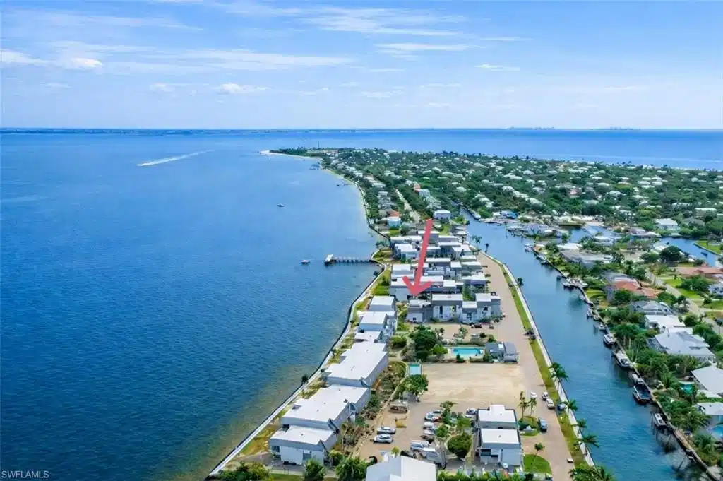 Image 1: Aerial perspective of suburban area with a large body of water