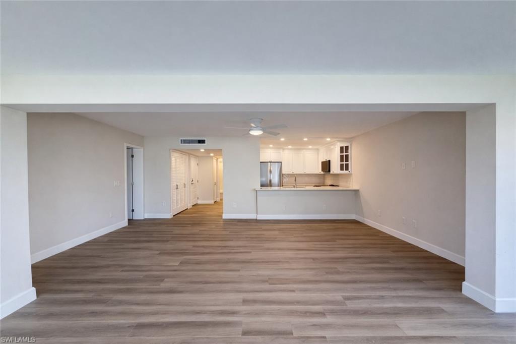 Image 2: Unfurnished living room featuring light wood-type flooring and ceiling fan