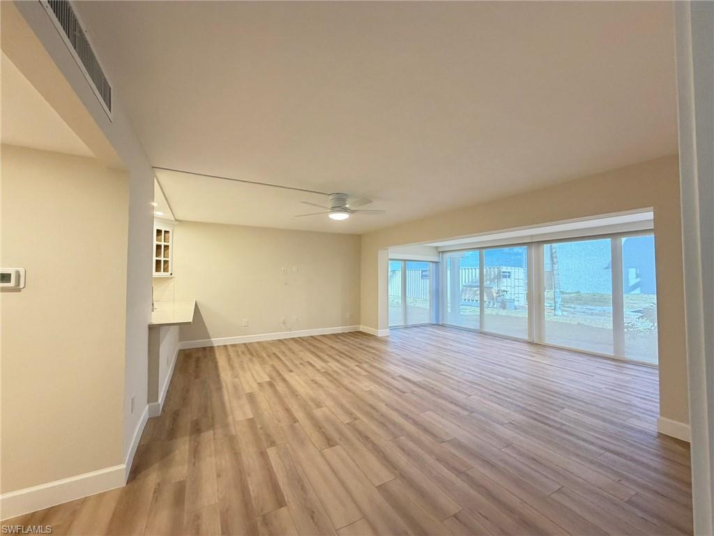 Image 3: Unfurnished living room with light wood-style flooring and a ceiling fan