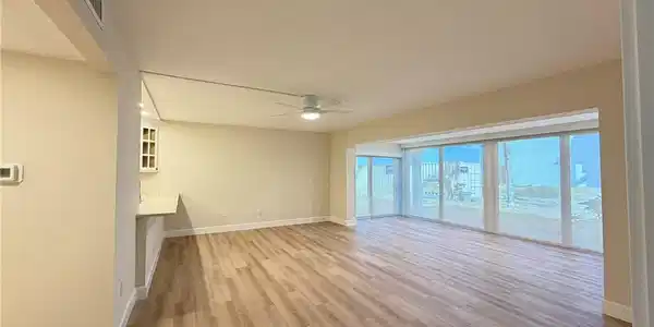 Image 3: Unfurnished living room with light wood-style flooring and a ceiling fan