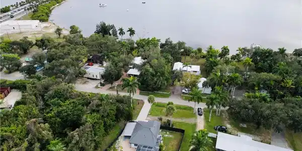 Image 3: Aerial view of property and surrounding area featuring a large body of water