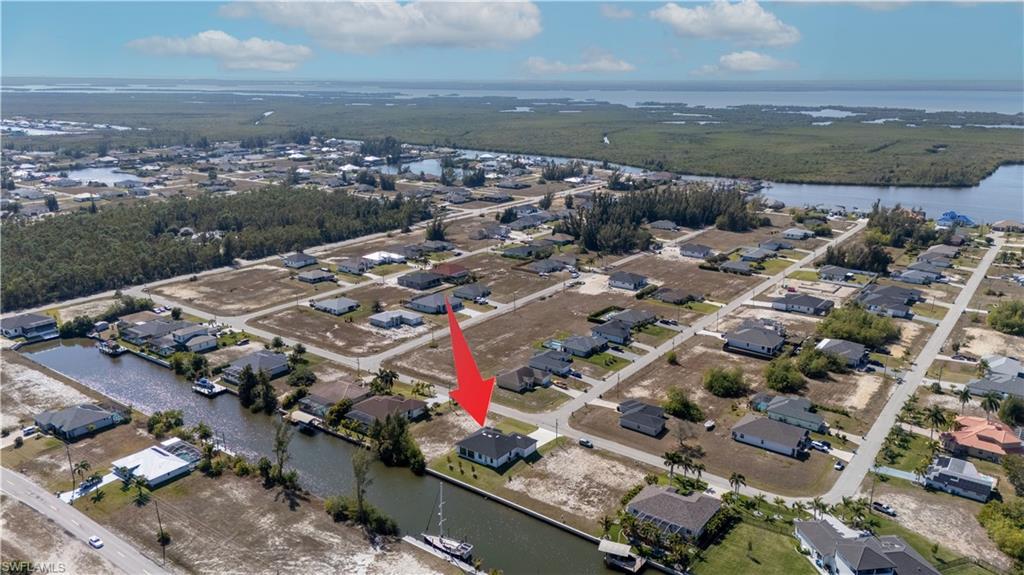 Image 4: View of property location featuring a large body of water and nearby suburban area