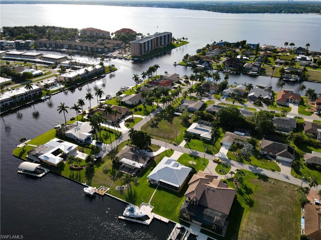 Image 3: Aerial view of property and surrounding area with a nearby body of water and nearby suburban area