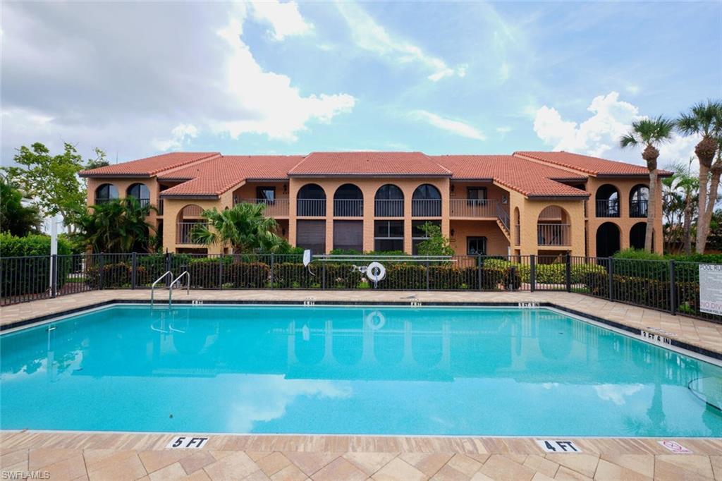 Image 1: Community pool featuring a patio