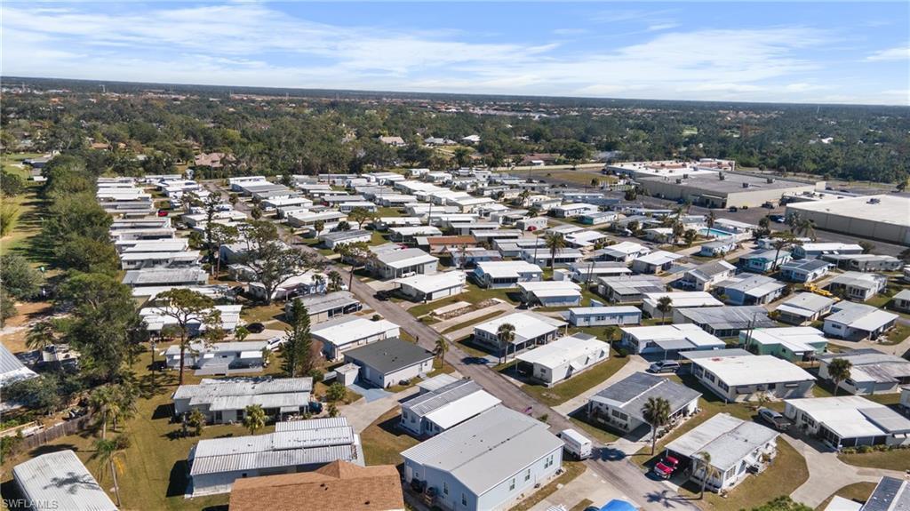 Image 3: Expansive residential community featuring numerous single-story homes, mature landscaping, and paved roads