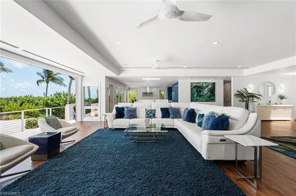 Image 1: Light-filled living room with soaring ceilings and expansive glass.