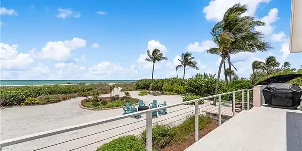 Image 4: Seamless indoor-outdoor living with panoramic beach views.