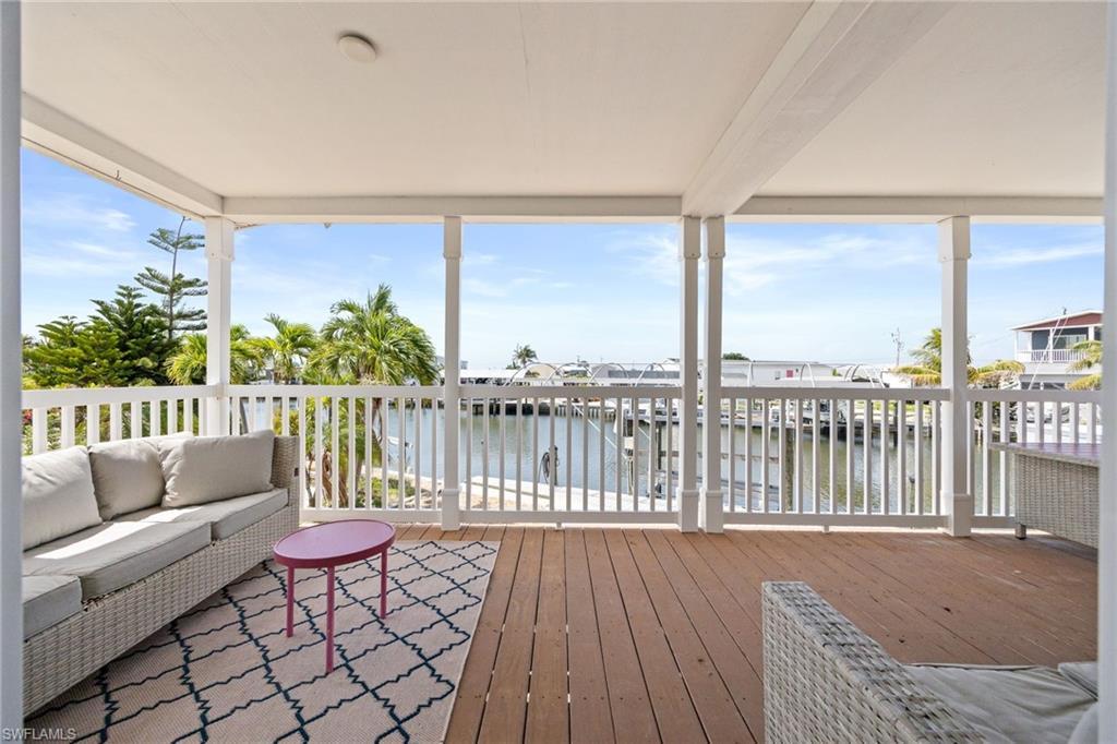 Image 3: Covered outdoor deck with canal front views to enjoy the island breezes and wildlife.