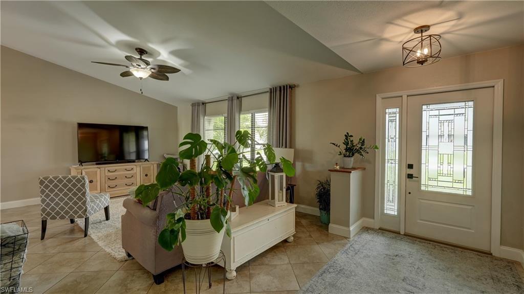 Image 4: Entryway featuring a white door with decorative glass, sidelight, and a geometric flush-mount light fixture