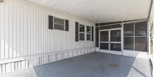 Image 4: Screened porch with concrete flooring and white vinyl siding