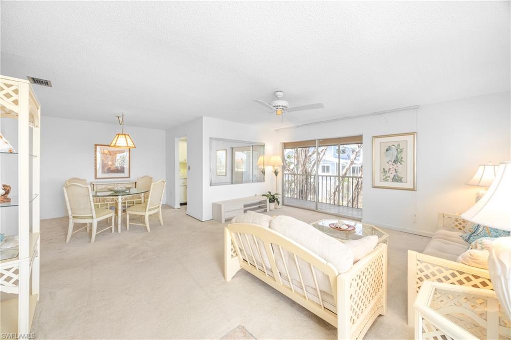Image 4: Bedroom with light carpet, visible vents, ceiling fan, and access to exterior