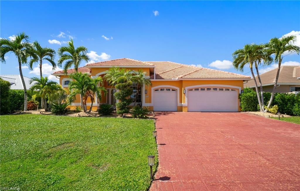 Image 2: Mediterranean / spanish-style house featuring a garage, a front yard, stucco siding, driveway, and a tile roof