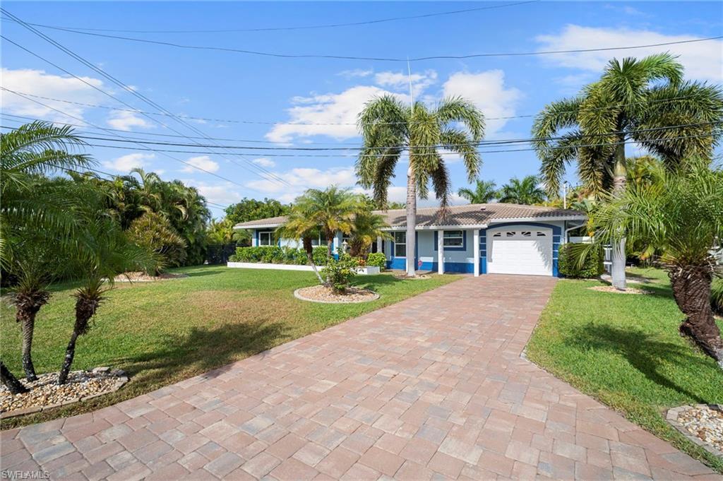 Image 3: Ranch-style home with a front yard, an attached garage, and decorative driveway