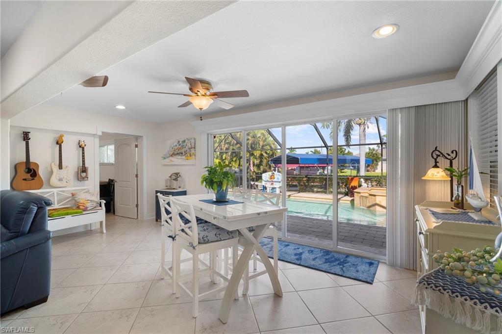Image 4: Dining area with a ceiling fan, a sunroom, light tile patterned floors, and recessed lighting