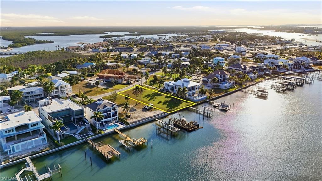 Image 3: Bird's eye view of a nearby body of water and numerous boat dockschange color of water into natural dark blue canal water