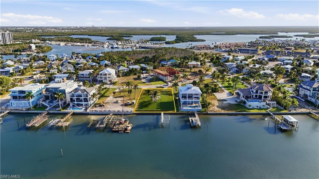 Image 4: Aerial perspective of suburban area featuring a large body of waterchange color of water into natural dark blue canal water