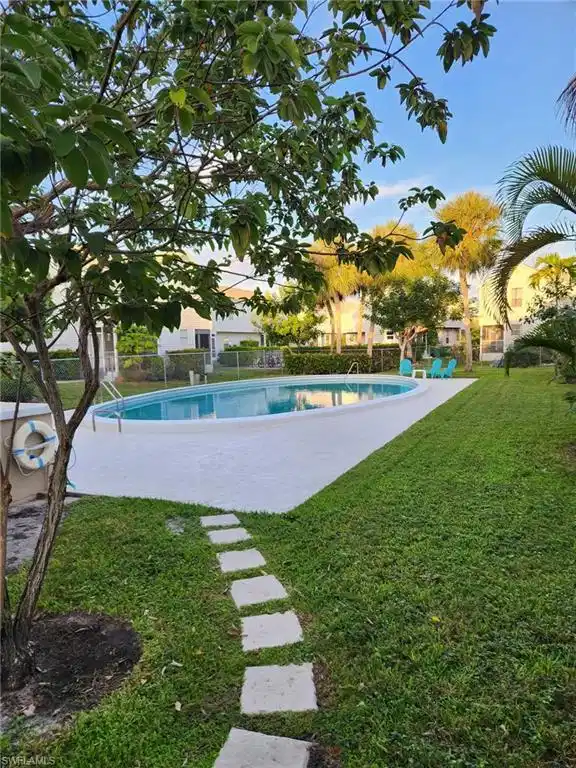 Image 1: View of pool featuring a patio
