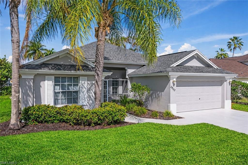 Image 2: Ranch-style home featuring a front lawn, an attached garage, concrete driveway, and stucco siding