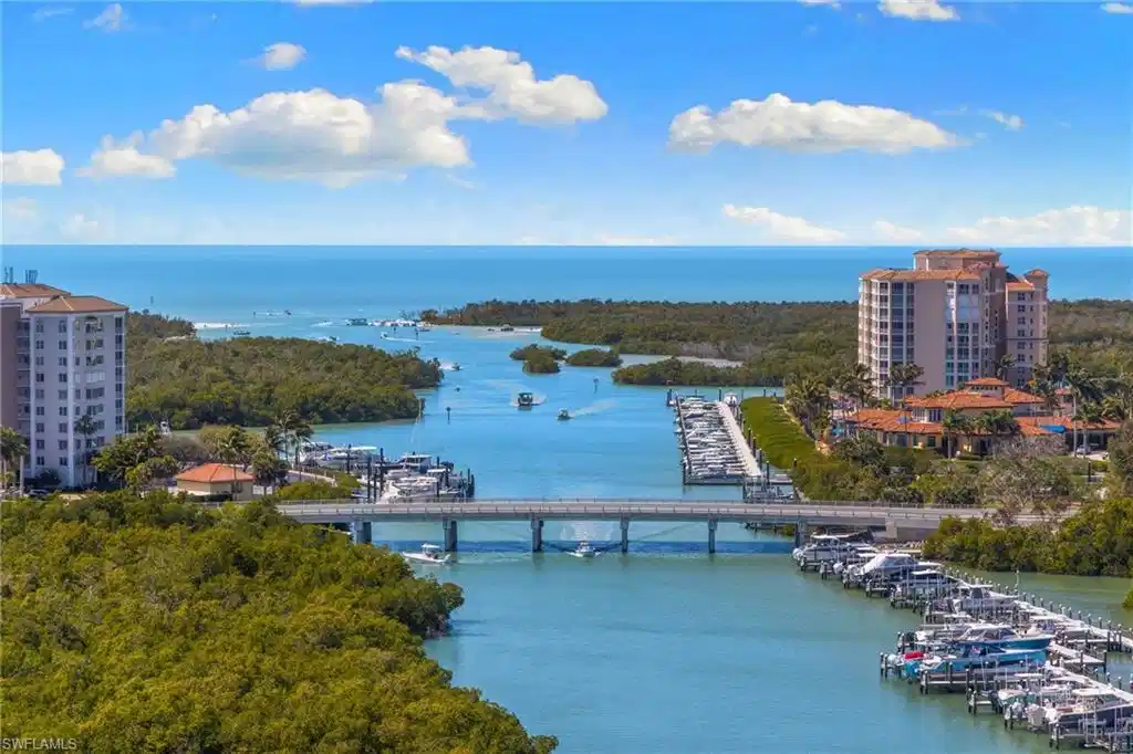 Image 1: Bird's eye view of a large body of water and a notable bridge