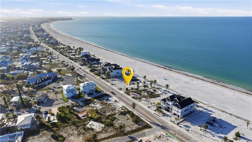 Image 2: Aerial perspective of suburban area with expansive beach - Virtually Edited Image