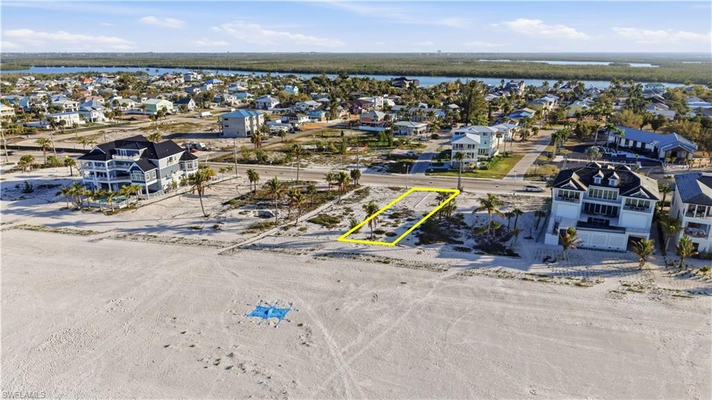 Image 3: Aerial view of residential area featuring property parcel outlined - Virtually Edited Image