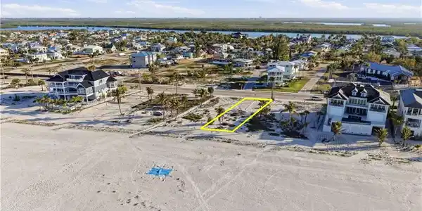 Image 3: Aerial view of residential area featuring property parcel outlined - Virtually Edited Image