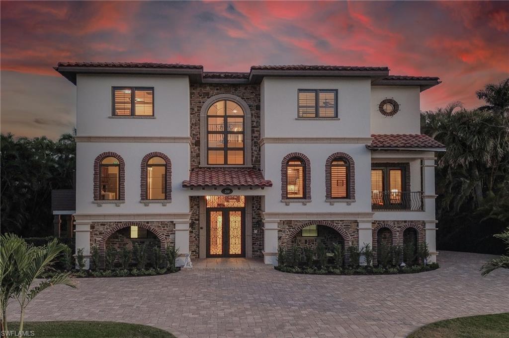 Image 4: Mediterranean / spanish home featuring french doors, stone siding, stucco siding, a balcony, and a tiled roof