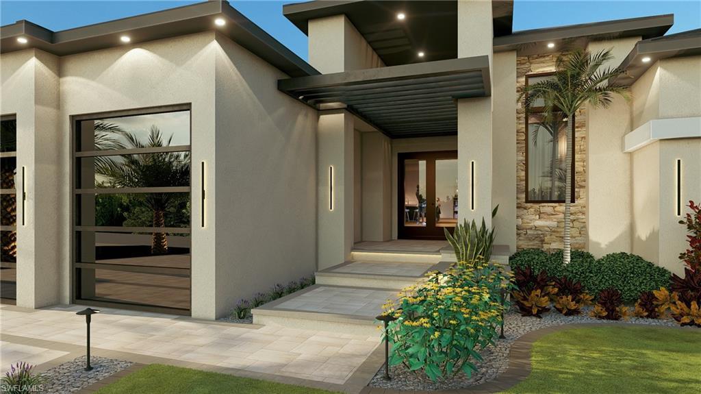 Image 3: Property entrance featuring french doors, stucco siding, and stone siding