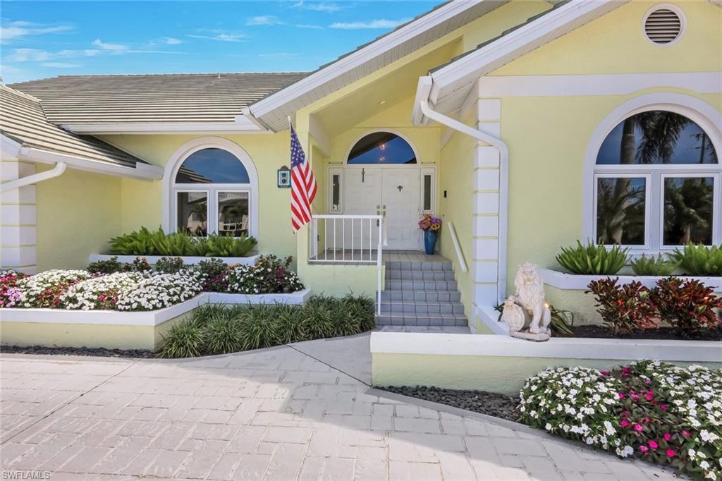 Image 2: Entrance to property featuring stucco siding and covered porch