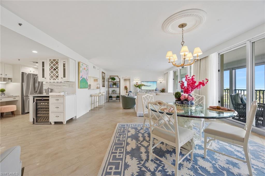 Image 3: dining area with views of kitchen and living room.