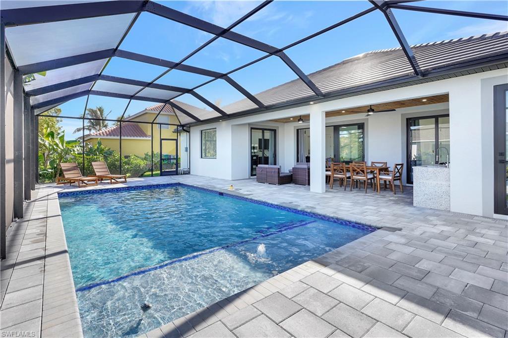 Image 2: Outdoor pool with a sunroom, a patio, a lanai, and a ceiling fan