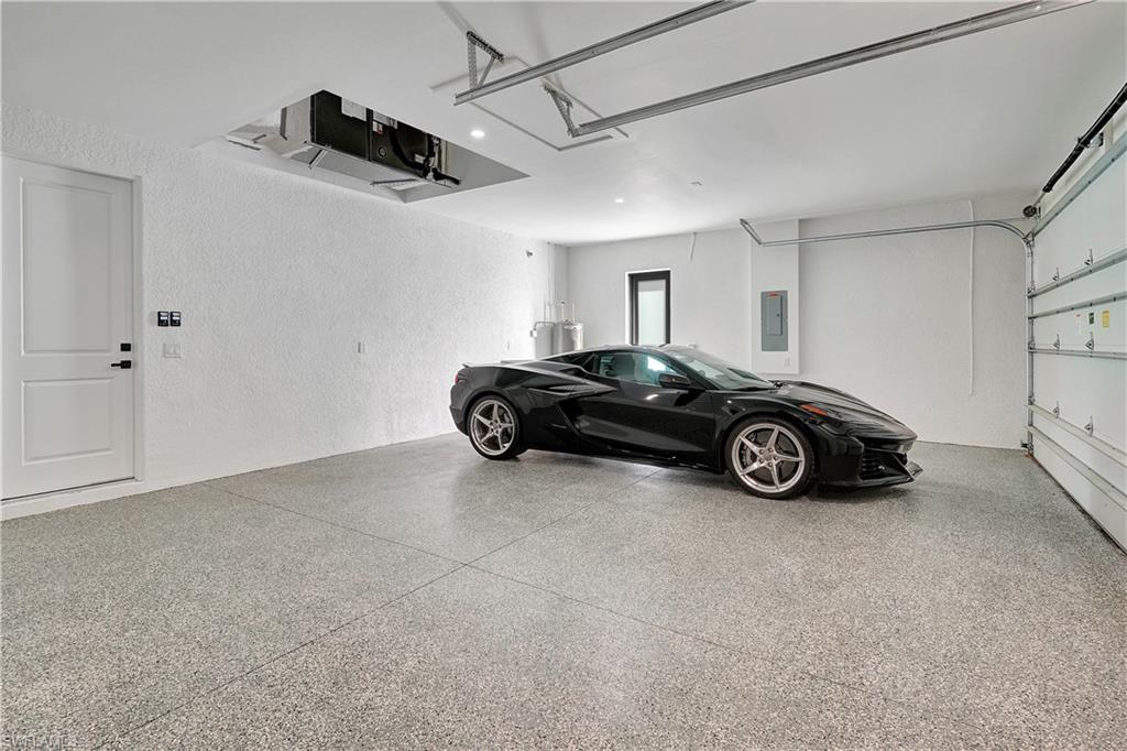 Image 4: Garage featuring a textured wall and electric panel