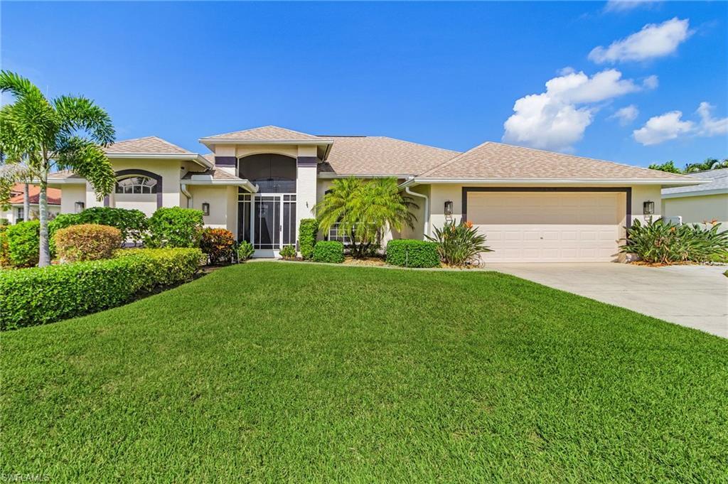 Image 2: View of front facade featuring stucco siding, a beautifully landscaped front lawn, driveway, an attached garage, and new shingle roof