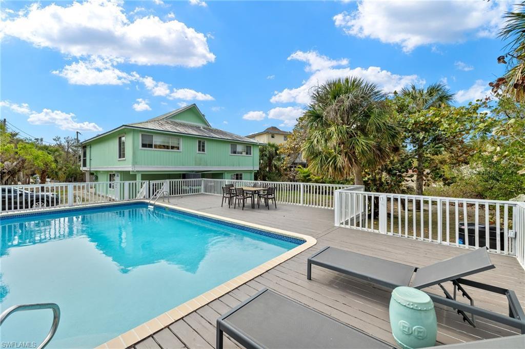 Image 3: View of pool featuring outdoor dining area, a patio area, and a deck