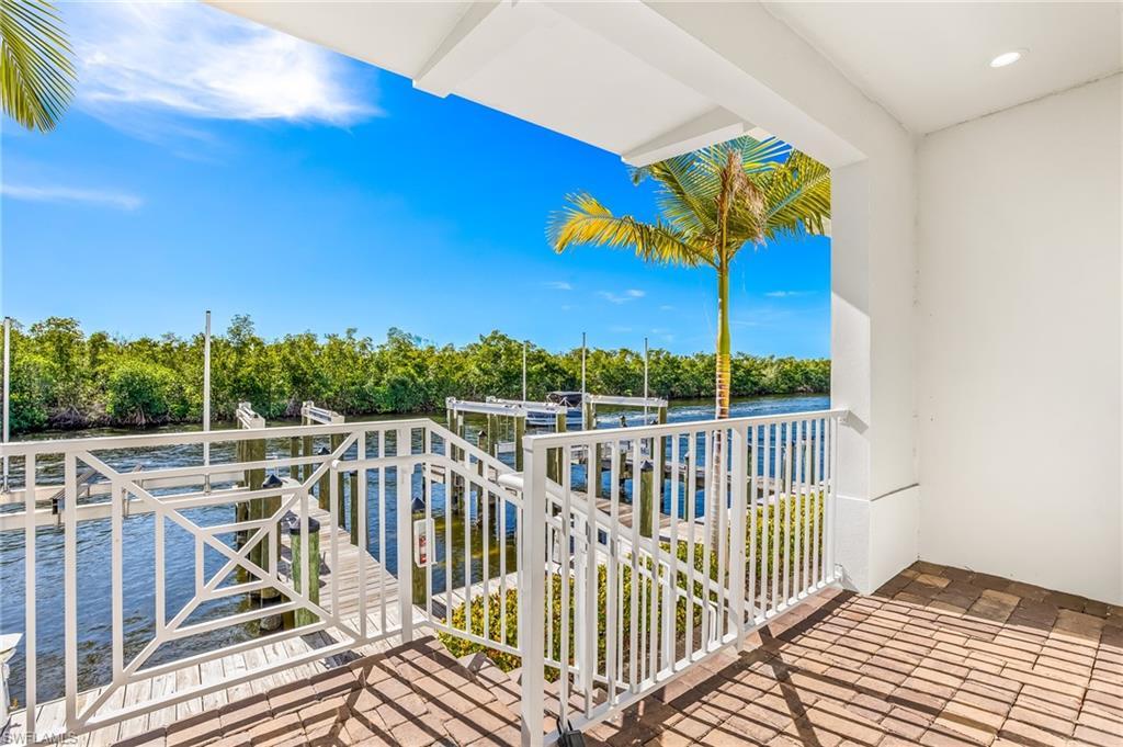 Image 4: Balcony featuring a water view, boat lift, and a boat dock