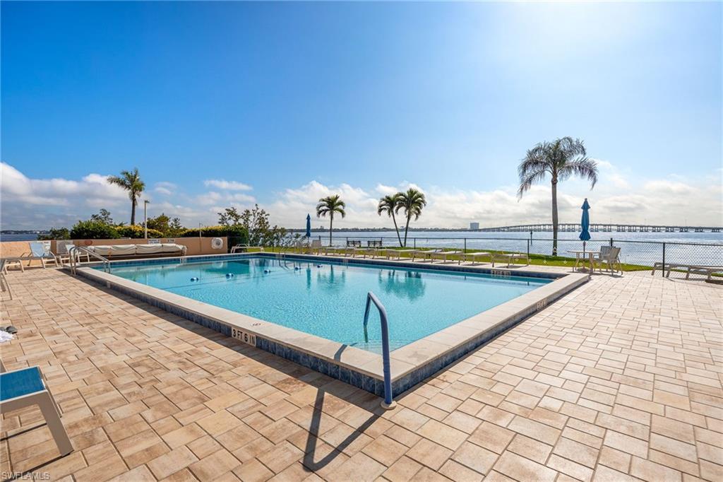 Image 3: Community pool featuring a patio area