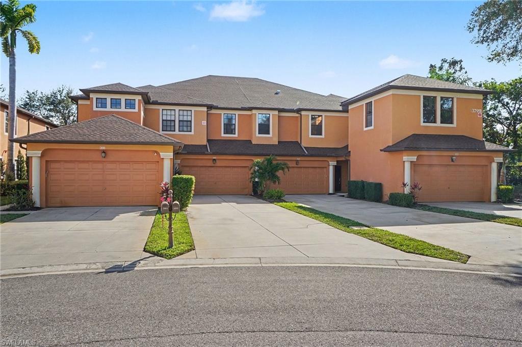 Image 3: View of front of home featuring stucco siding, concrete driveway, roof with shingles, and a garage