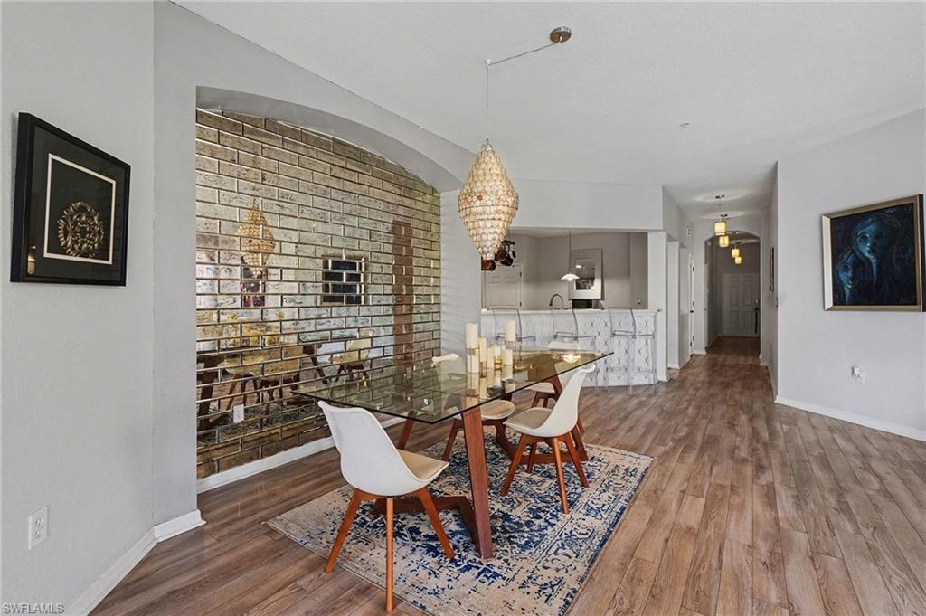 Image 4: Dining room featuring dark wood-style flooring and a chandelier