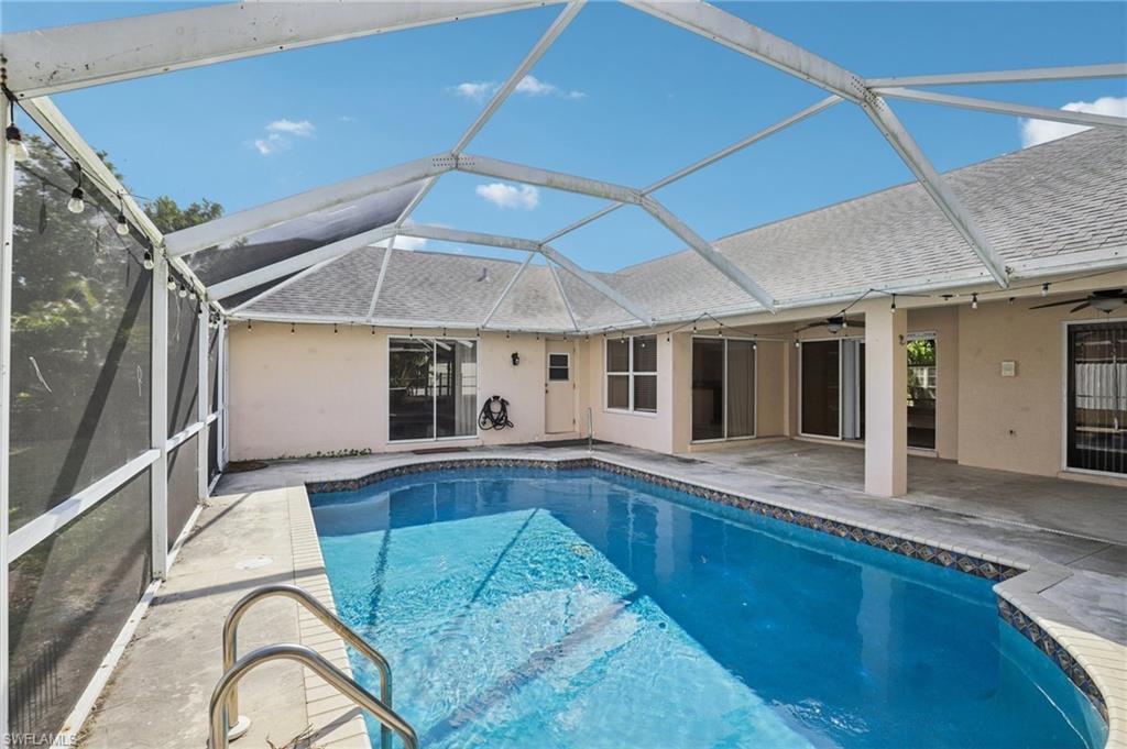 Image 2: Outdoor pool featuring a patio, a sunroom, and a lanai