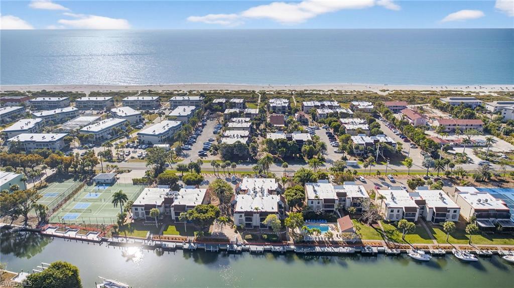 Image 1: Aerial perspective of suburban area with a nearby body of water