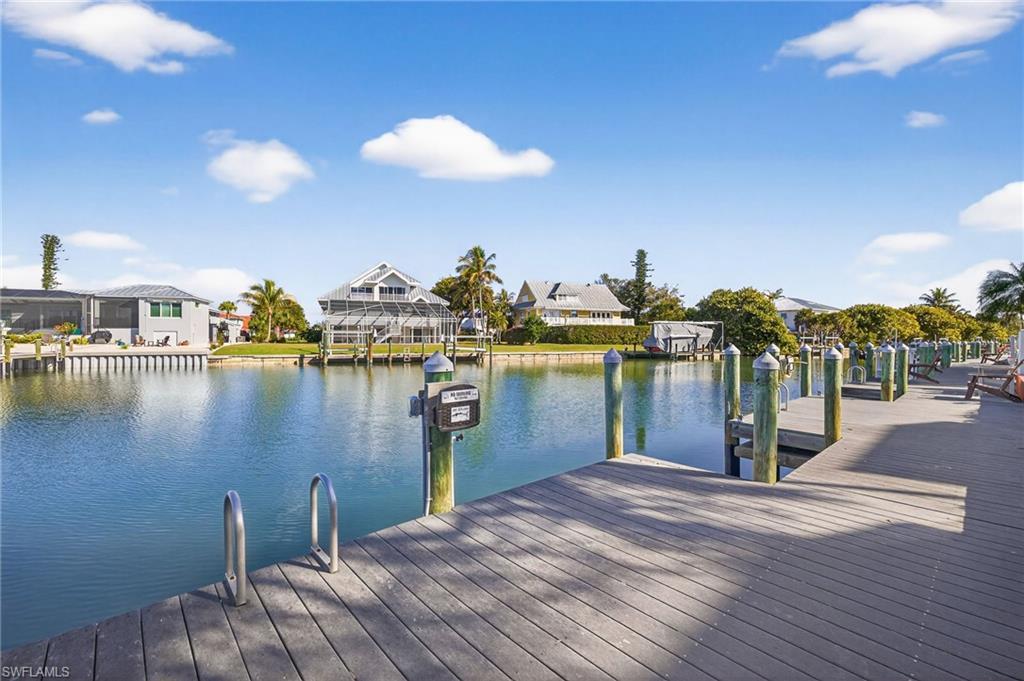 Image 2: Dock featuring a water view and a residential view