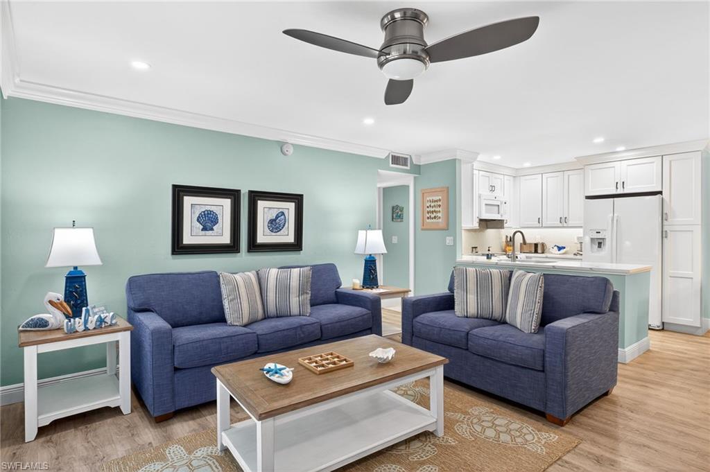 Image 4: Living room with recessed lighting, crown molding, light wood-style flooring, and ceiling fan