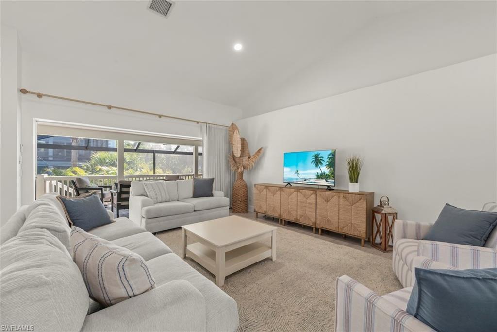 Image 2: Carpeted living room featuring lofted ceiling and recessed lighting