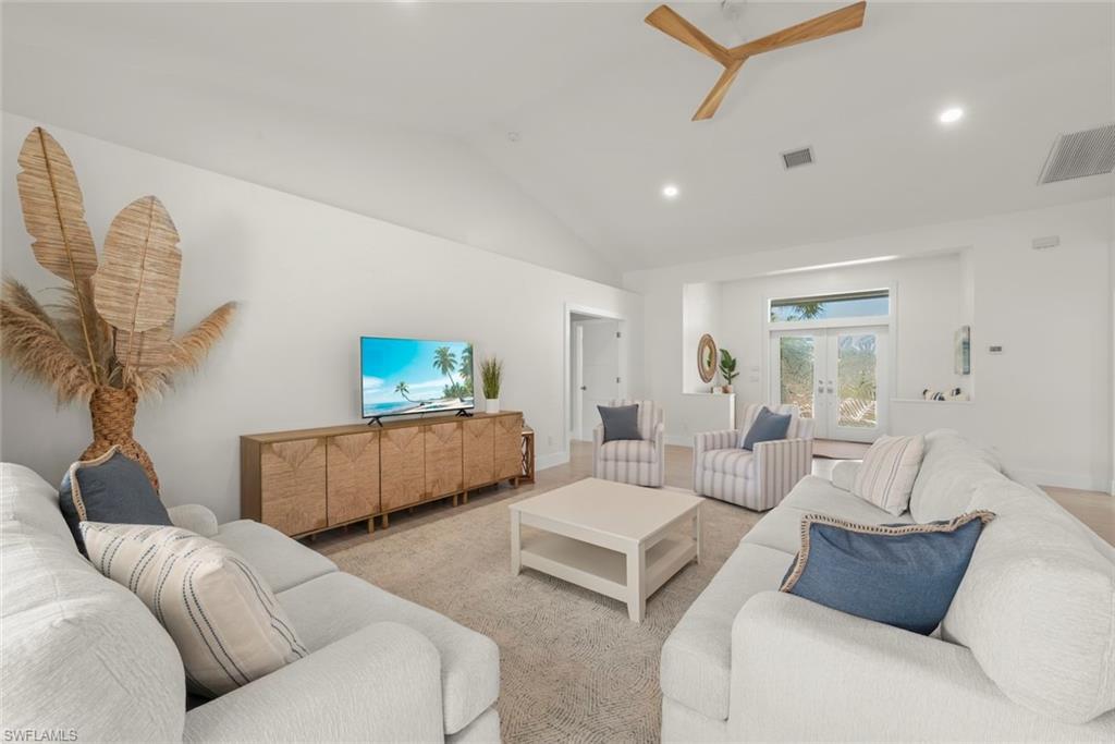 Image 4: Living room with french doors, vaulted ceiling, recessed lighting, and a ceiling fan