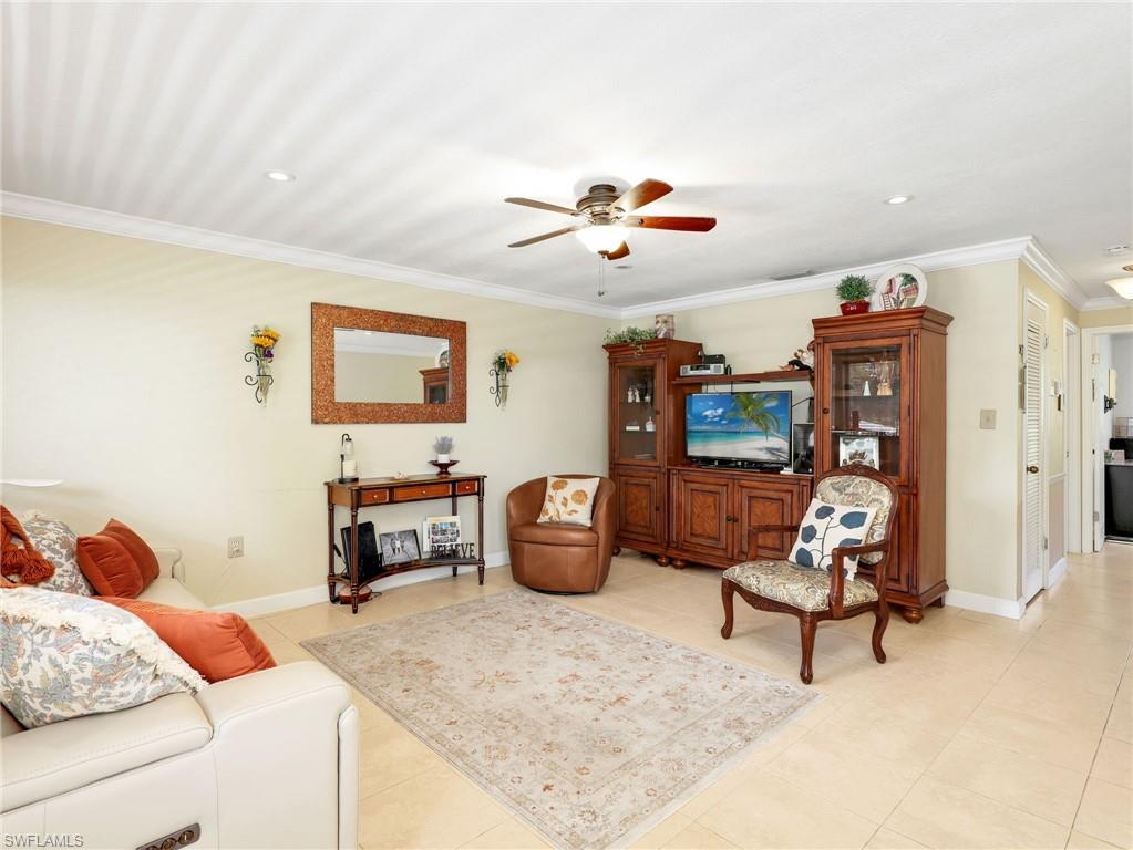 Image 3: Living room featuring a ceiling fan, ornamental molding, light tile patterned flooring, and recessed lighting