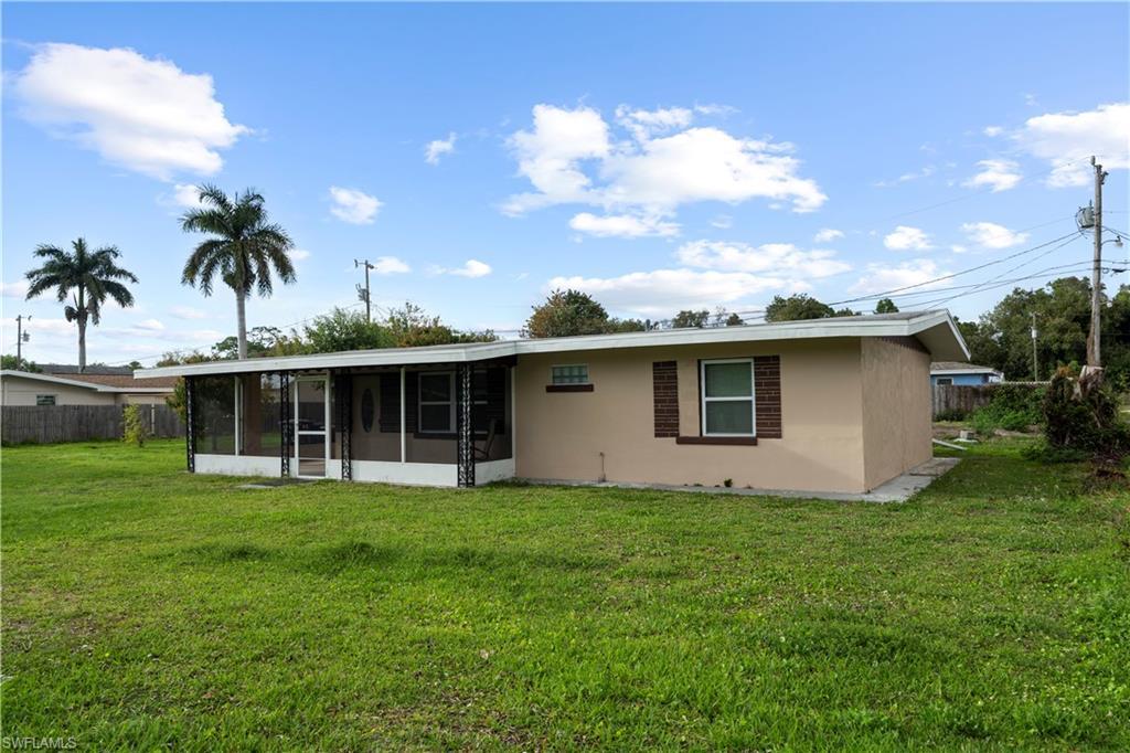Image 2: Front of property with a sunroom and stucco siding