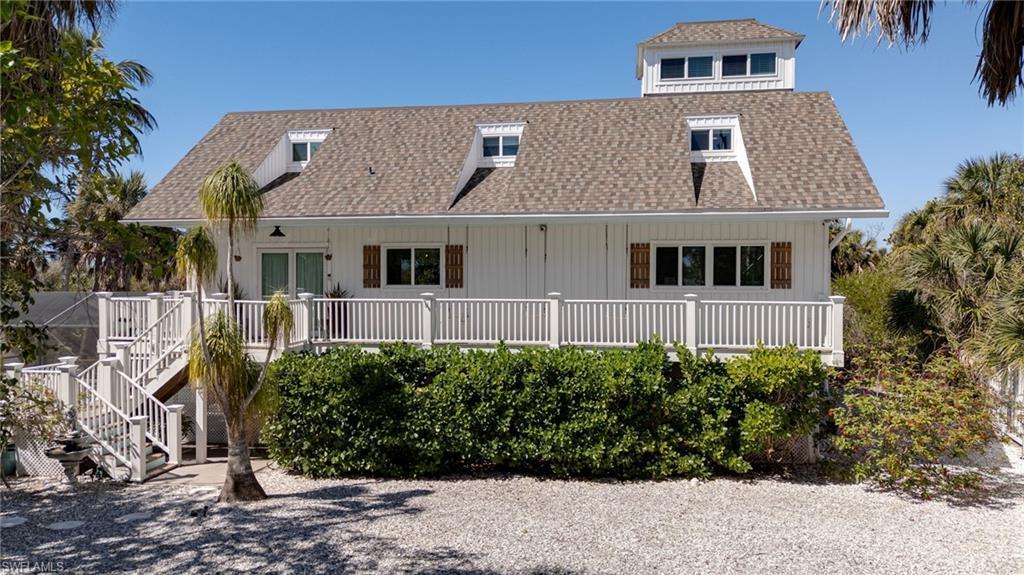 Image 4: Front Elevation Features a New Roof, Siding, Porch Swings and a Happy Ponytail Palm!